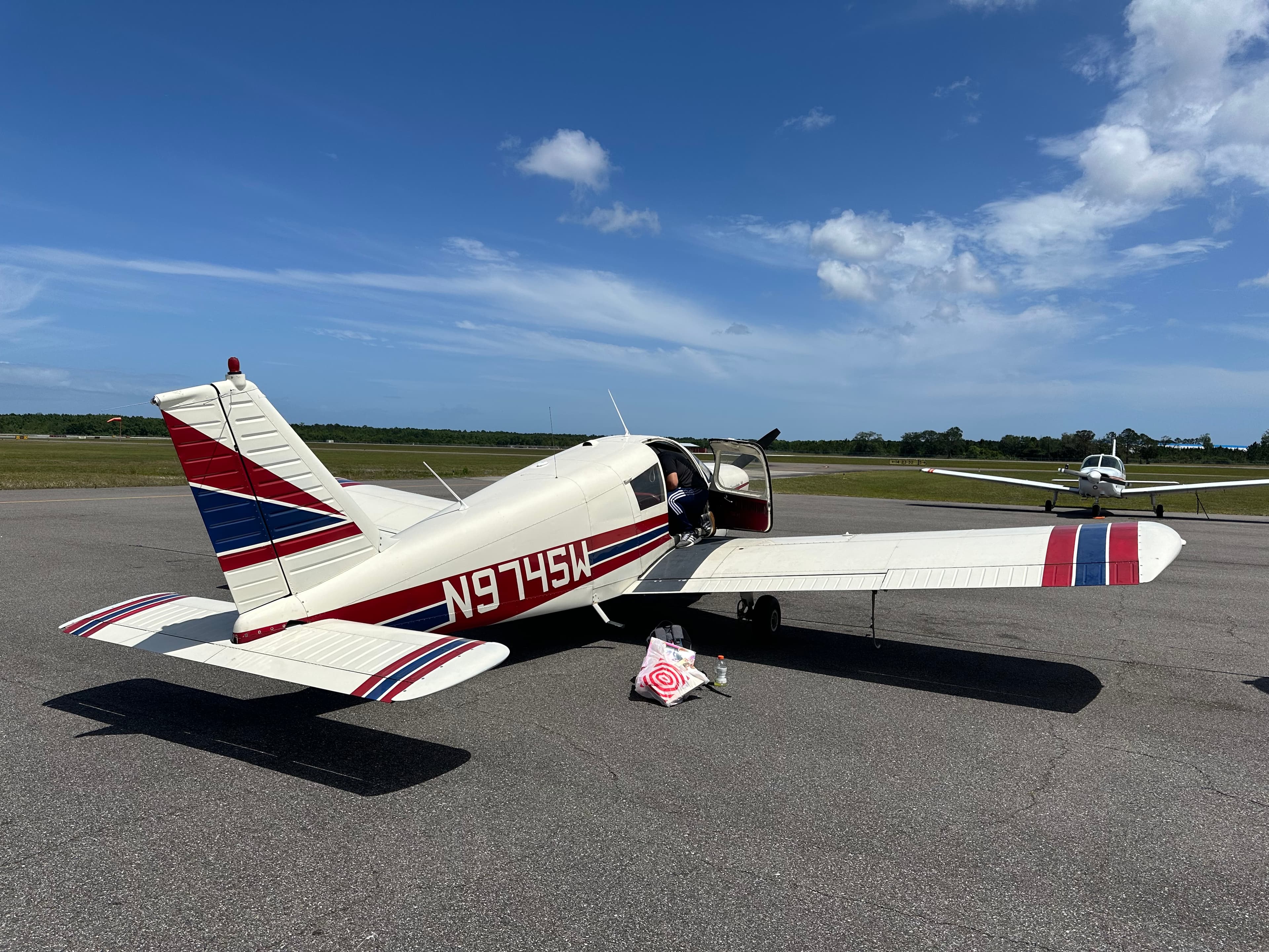 Our PA-28-140 Cherokee on the ramp at Concord-Padgett (KJQF), doors open