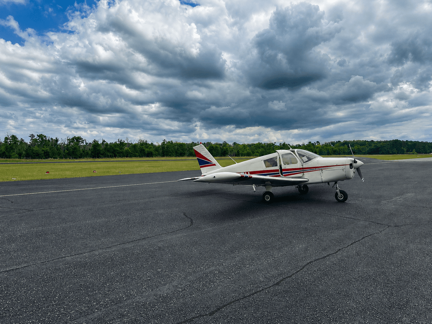 Our PA-28-140 Cherokee, side profile, on the ramp